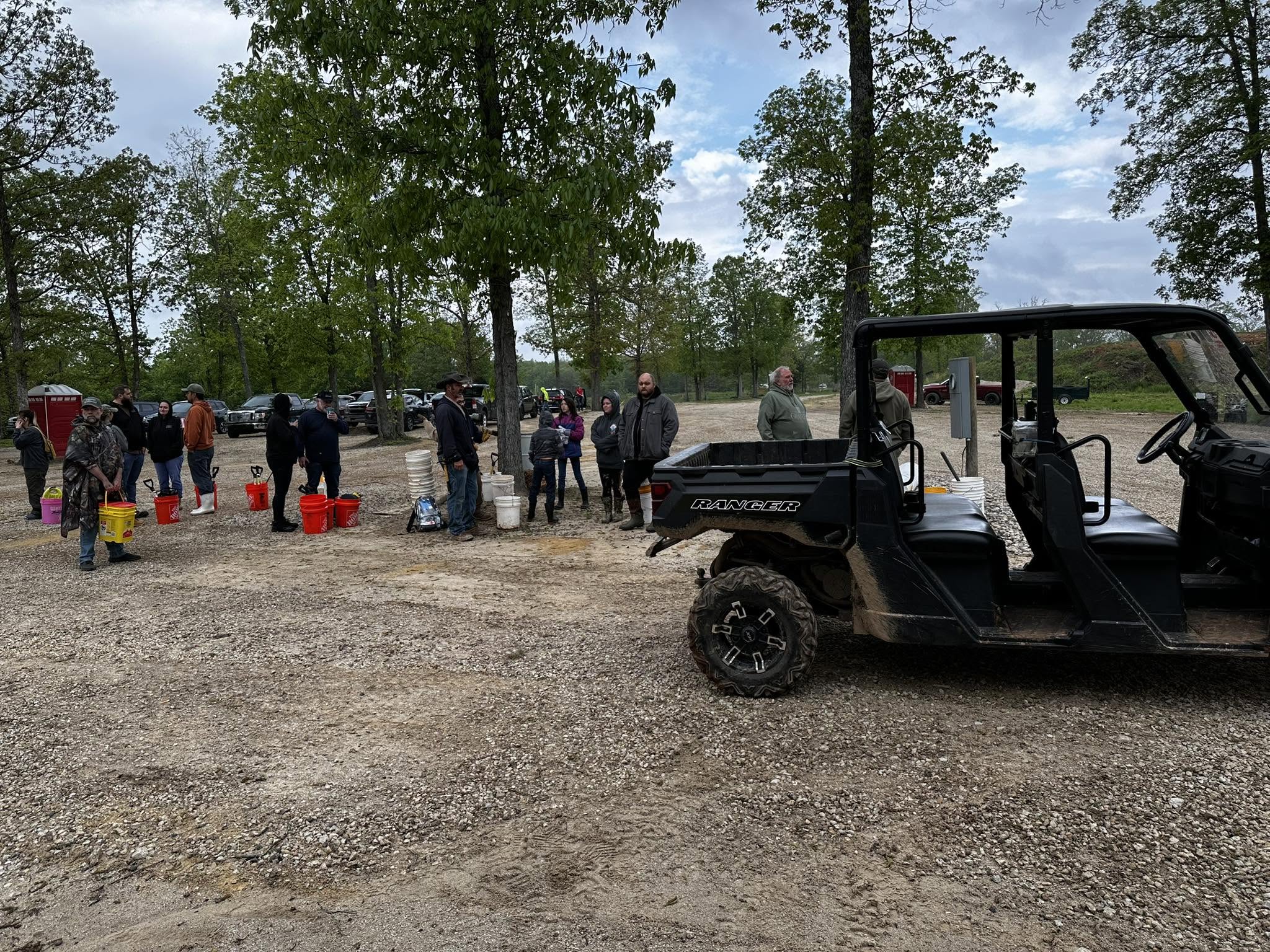 Polaris Ranger beside visitors and their buckets at Haunted Ridge Rocks